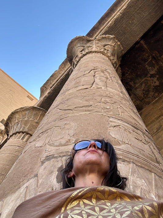 Stephanie sitting with head against column in Egyptian temple.