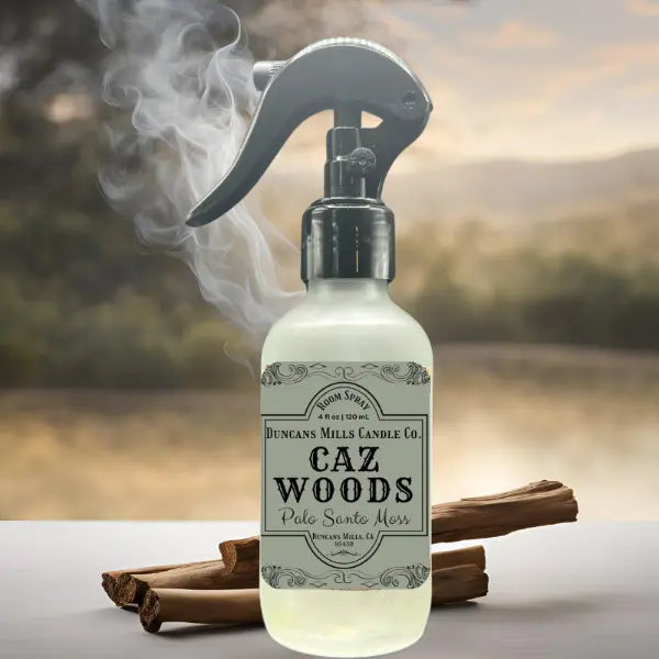 Caz Woods Linen & Room Spray in frosted glass with black trigger with palo santo burning