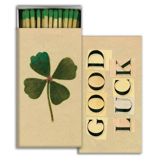 Matchbox with four-leaf clover and 'Good Luck' text on a white background