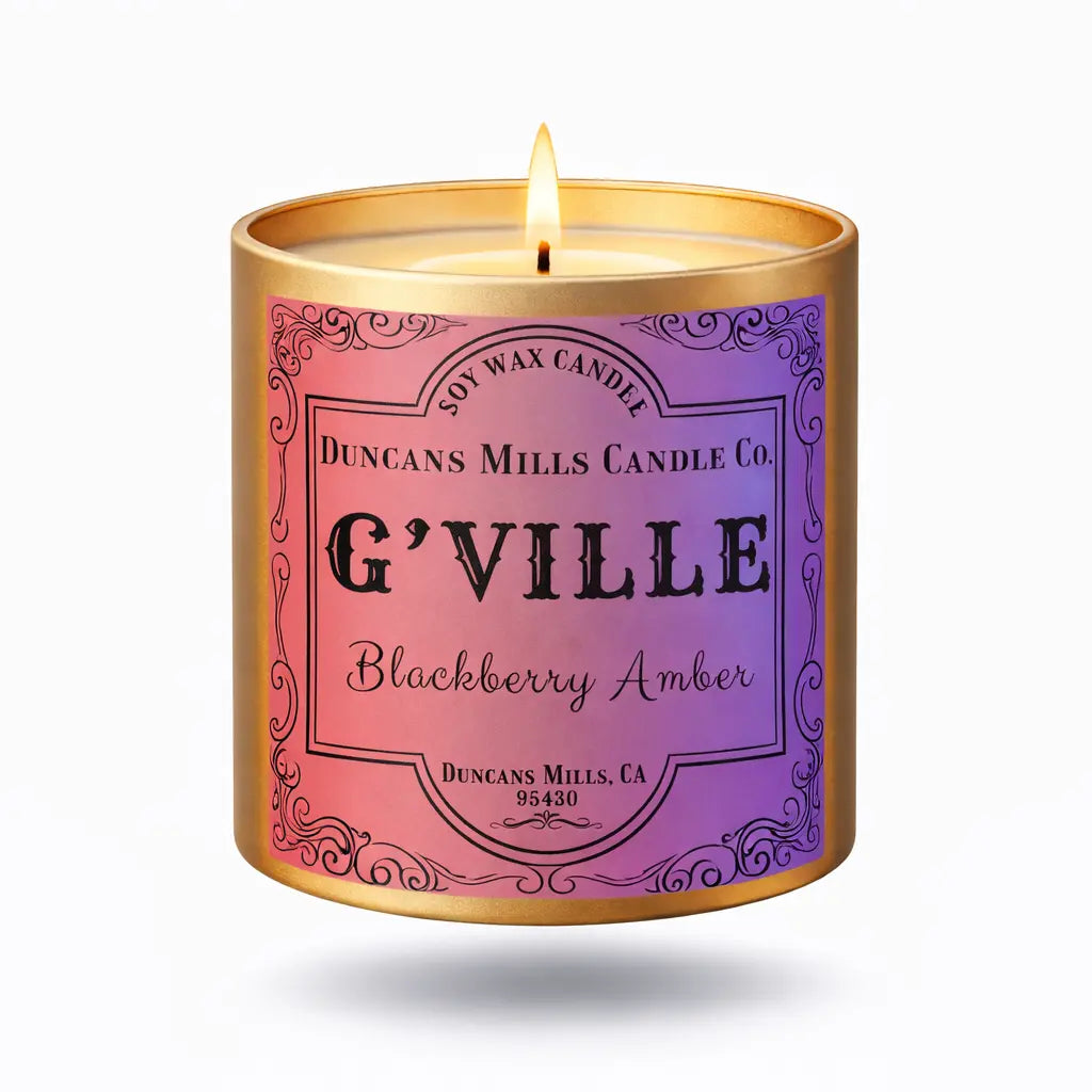 Candle in a decorative container labeled 'G'Ville Blackberry Amber' by Duncan Mills Candle Co.