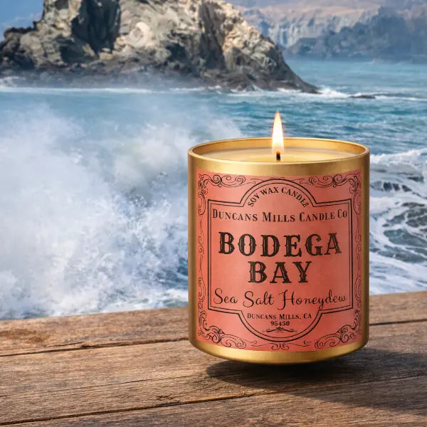 Bodega Bay infinity tin candle on rustic table with ocean spray background by Duncans Mills Candle Co.