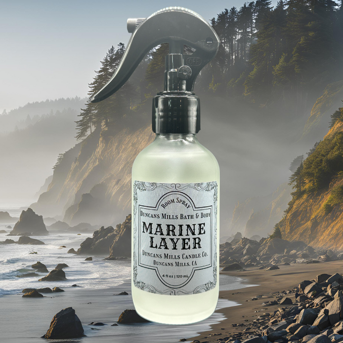 Marine Layer Room & Linen Spray in a frosted glass bottle with a black trigger sprayer, featuring a fresh and grounding scent of bergamot, moss, and ocean air. Handcrafted in small batches in Duncans Mills, California.