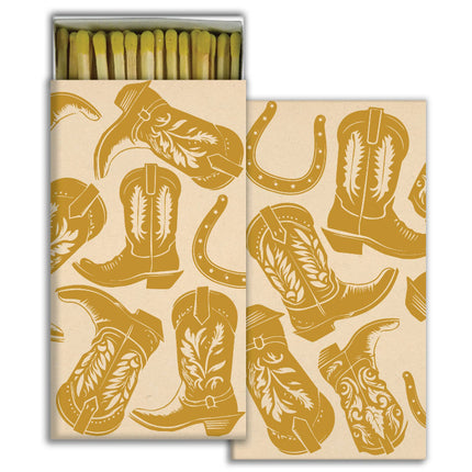 Matches in matchbox with gold kicking boots design and horseshoes.