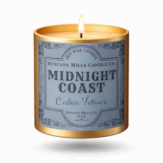 Midnight Coast soy wax candle in a gold tinl on a white background