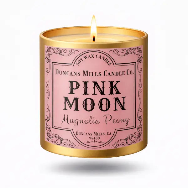 Pink Moon candle with gold lid on a white background