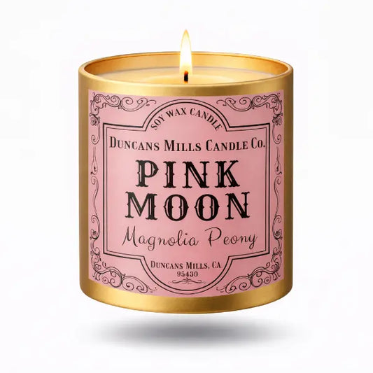 Pink Moon candle with gold lid on a white background