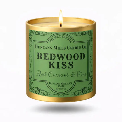 Redwood Kiss soy wax candle in a gold tin on a white background