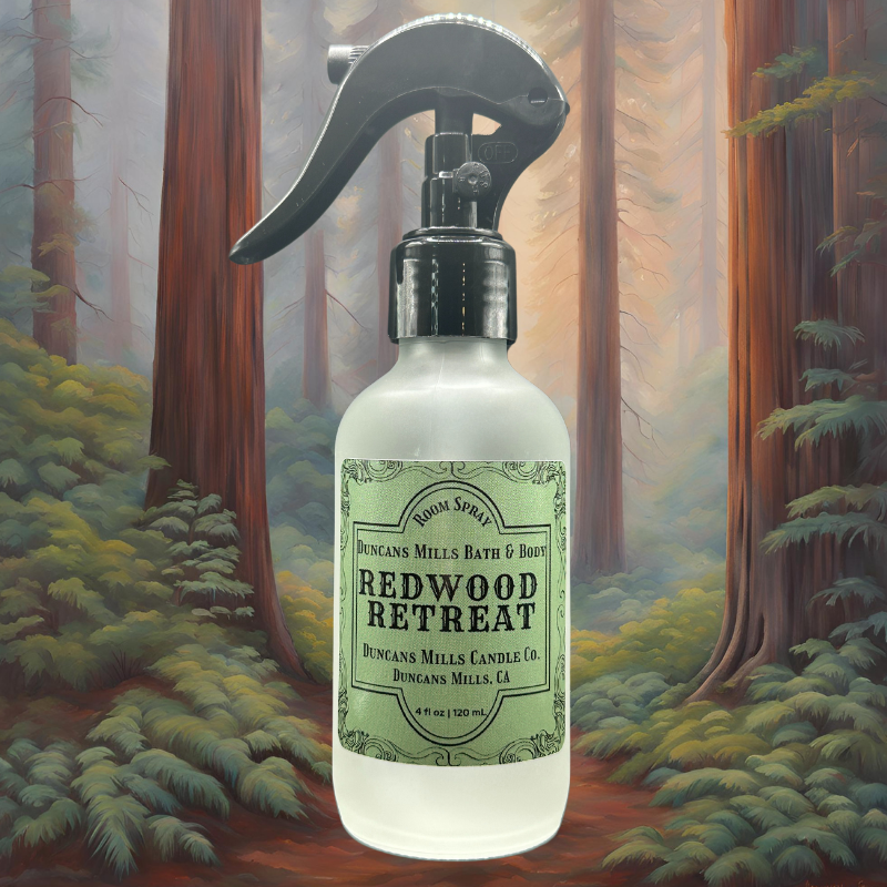 A bottle of Redwood Retreat Room & Linen Spray nestled in a graphic of redwood trees, capturing the fresh, earthy essence of the Russian River’s towering forests.