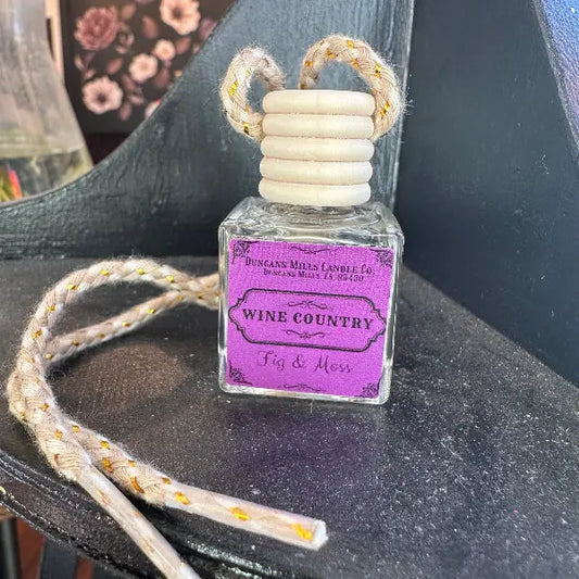 Car diffuser wine country with fig & moss scent displayed elegantly on a wooden surface.