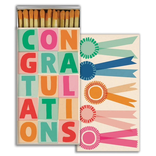 Matches box with 'Congratulations' text and colorful ribbons on a white background